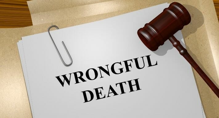 The word wrong death is written on a piece of paper, representing a personal injury or auto accident attorney's acknowledgment of a tragic incident.