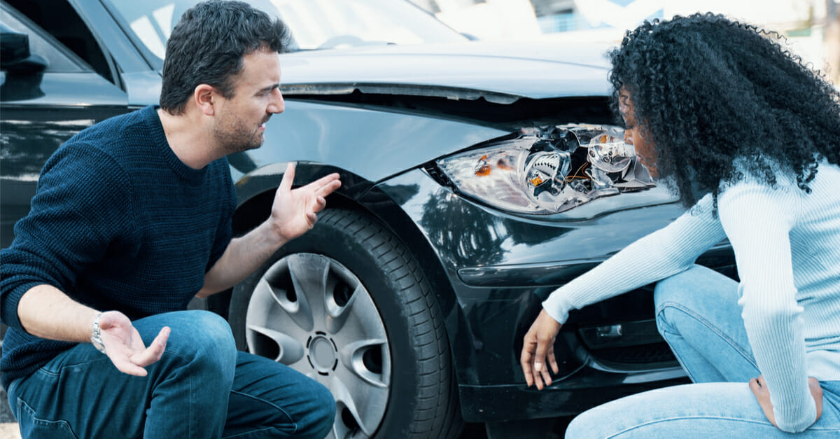 A man and woman discussing an auto accident.
