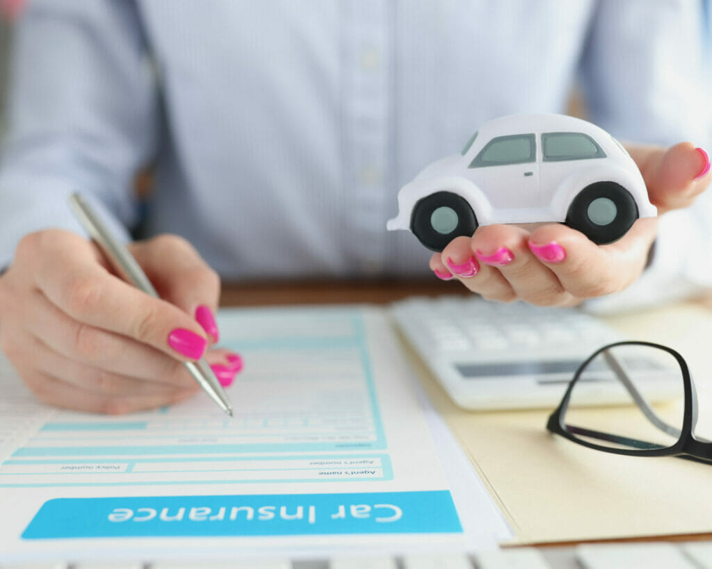 A woman holding a toy car representing uninsured drivers, and symbolizing insurance companies.