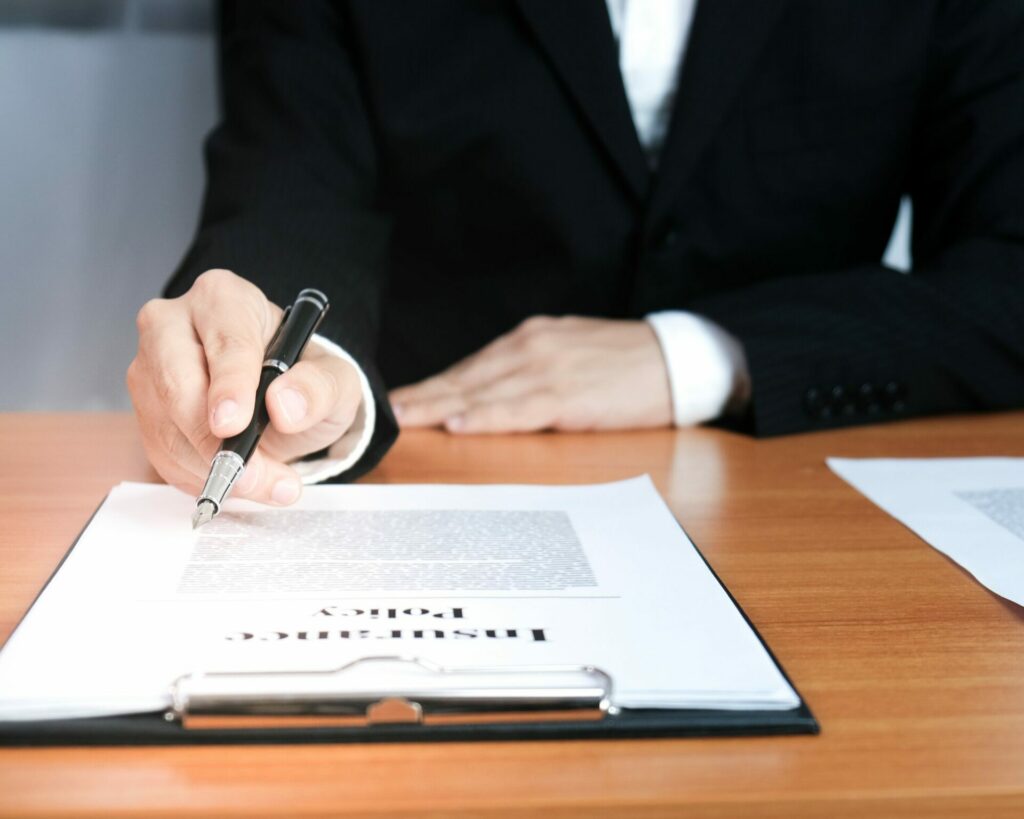 Lawyer signing a document to sue a motorcycle company.