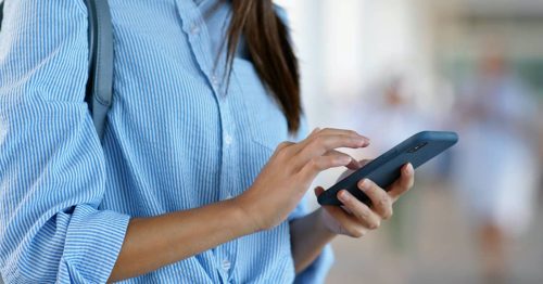 Person with a cell phone in their hand