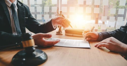 A person signing a contract.