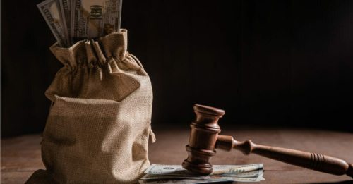 gavel and a bag of money.