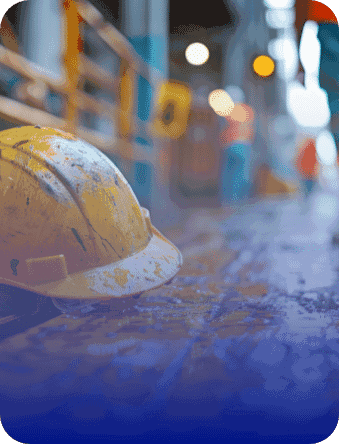 Yellow hard hat lying on the ground at a construction site with blurred background